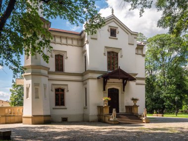 The beautiful architecture of the old house in the village. Kepinski Palace with a palace park in the center of Szczurowa