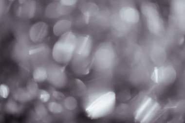 Siyah arkaplanda siyah bokeh dokusu. Arkaplanda soyut siyah beyaz parıltı bokeh.