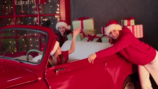 Buon Natale e consegna di Capodanno. Ragazze in auto d'epoca rossa offre regali. — Video Stock