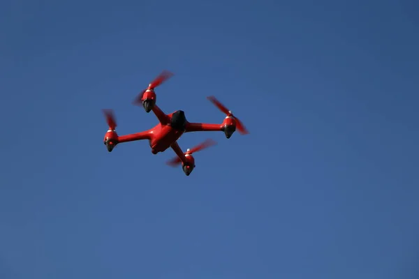 Red drone on a blue sky background — стоковое фото