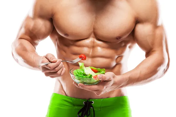 Форма и здоровое тело человек держит свежий салат миску, в форме АБ Лицензионные Стоковые Фото