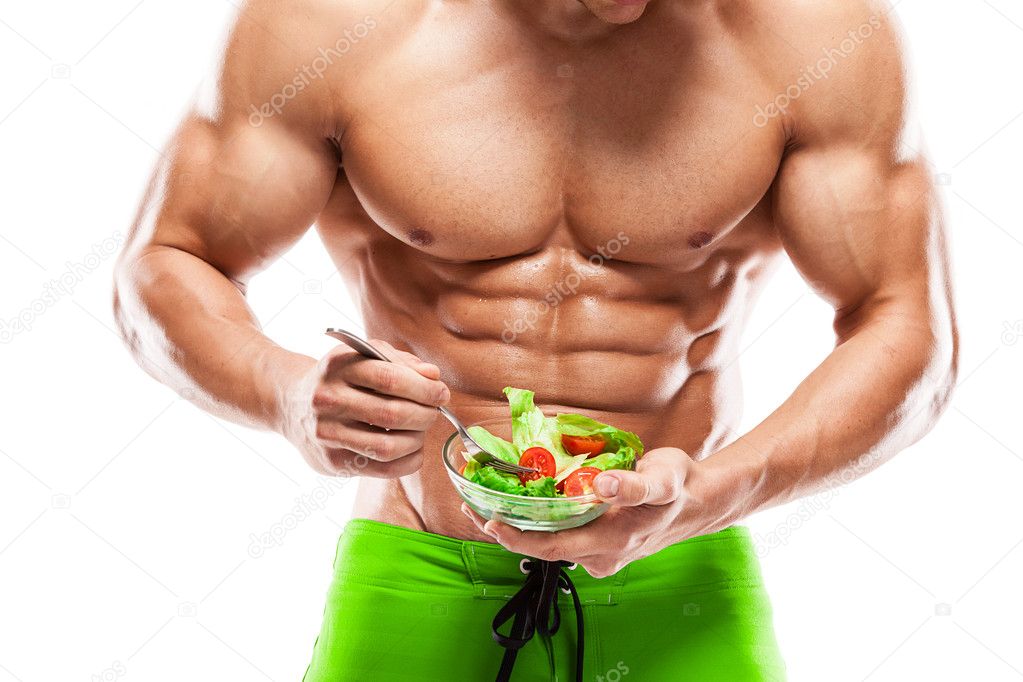 Shaped and healthy body man holding a fresh salad bowl,shaped ab