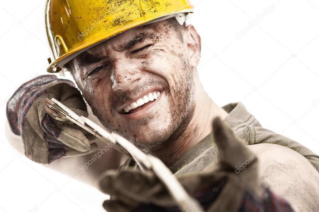Portrait of dirty worker with helmet measuring with classic wood
