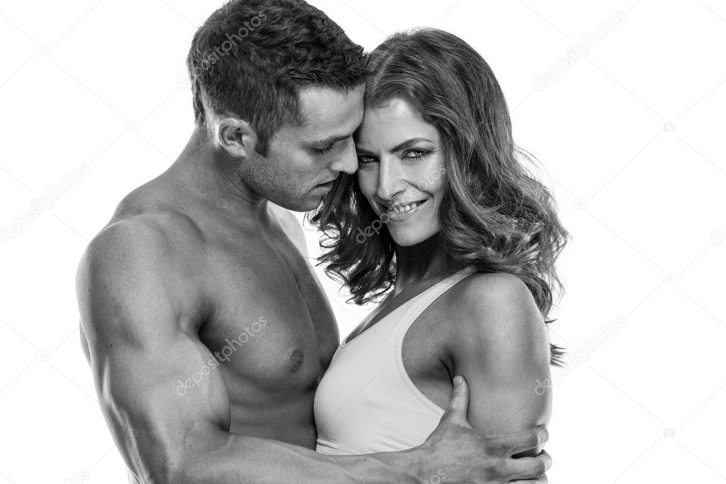 sexy couple, muscular man holding a beautiful woman isolated on 