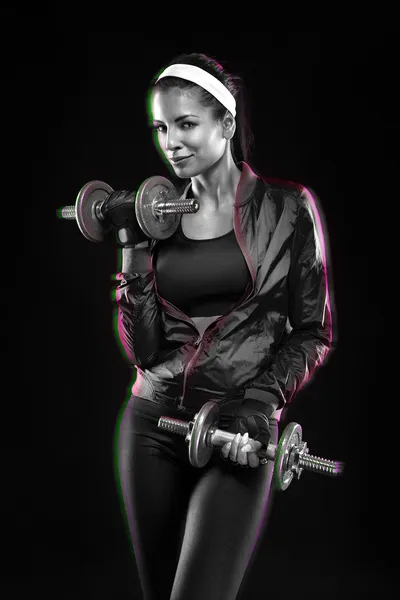 Woman exercises with dumbbells — Stock Photo, Image