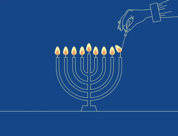 Hand Lighting Candle On Metal Hanukkah Menorah On Surface Against Blue Background. Man lighting up candles in menorah. Jewish Woman Celebrating Holidays Hanukkah