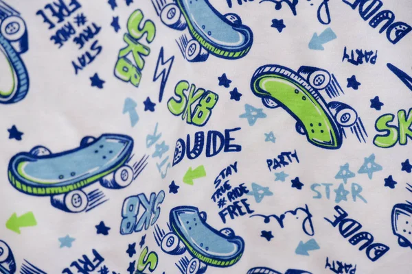 Kumaş deseni kumaş üzerinde resimler ve harflerle basılmış..