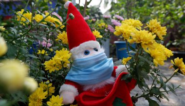 25 Aralık Noel günü Corona virüsünden korunmak için yüzünde cerrahi maske olan Noel Baba..