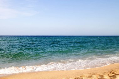 Waves, sea, beach, clear water. Bridge in the water.