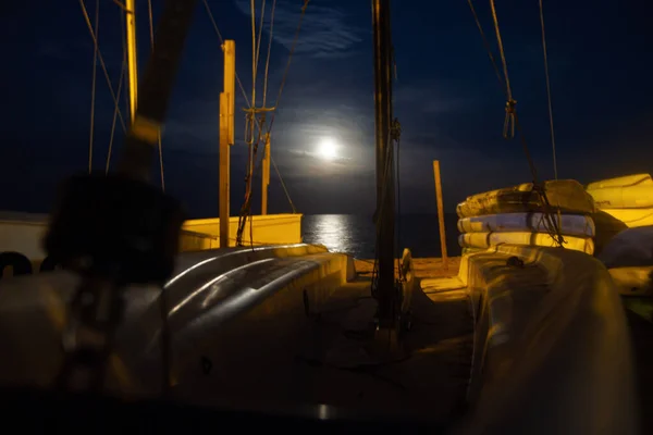 Boats, moon sea, night. Moon path.