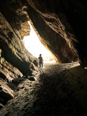 The natural caves of Barayo beach, Asturias, Spain, formed by marine erosion, holiday tourist destination,