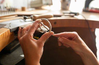 El yapımı. Deri kemer için kendi ellerinle element yapıyorsun. Bir atölyede bir dosya ve çekiçle metal bir toka yapmak.