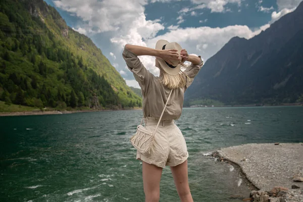 Young Woman Stands Shore Lake Her Hands Backdrop Nature High — Stockfoto