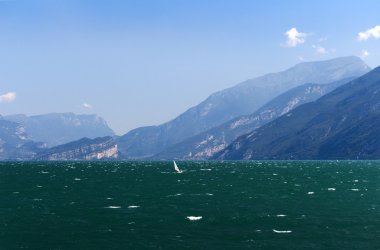 The Waters of Lake Garda and views of the lovely towns clipart