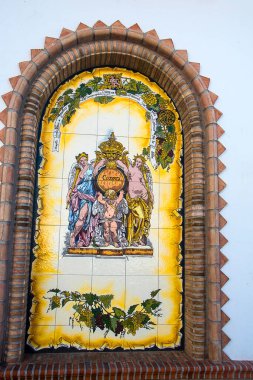 Competa is a white town in the mountains above Mlaga in Andalucia southern Spain. It is known for its fine church with plaques of traditional  trades of the area on its side wall and courtyard