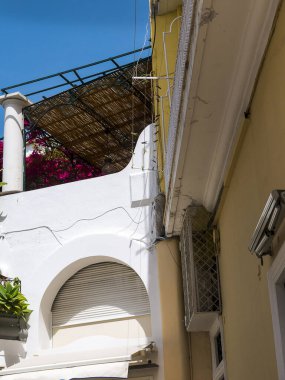 Capri has been a resort island since Roman times . It is situated in the Bay of Naples and is covered with architecture from all the successive generations