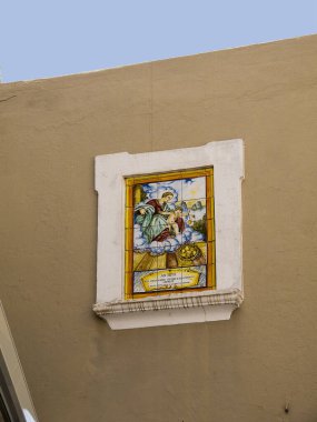 Religious Plaque on Wall on the Isle of Capri.Capri has been a resort island since Roman times . It is situated in the Bay of Naples and is covered with architecture from all the successive generations