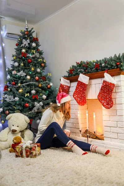 Jovencita Suéter Blanco Sentada Con Taza Cerca Chimenea Árbol Año —  Fotos de Stock