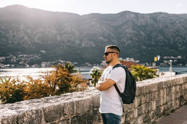 Adam Karadağ 'daki Kotor eski duvar kalesinde duruyor. Unesco 'nun dünya mirası. Avrupa seyahat alanı. Tatil konsepti. Adriyatik Denizi 'nde turizm. Sırbistan 'ın Balkanlar, kale ve liman tarihi