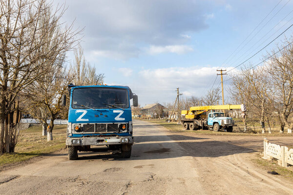 Barmashovo, Ukraine - March 18, 2022: War of Russia against Ukraine. Concept of invasion. Stolen Ukrainian KAMAZ truck in the village with Z fascist  Russian symbol left after invasion battle with ZSU
