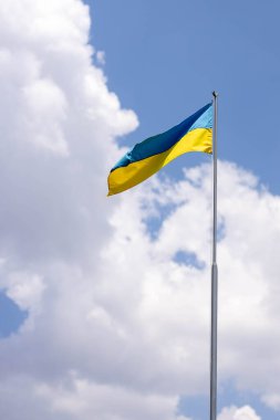Ukraine flag large national symbol waving on the blue sky with clipping path. Large yellow blue Ukrainian state flag, Independence Constitution, National holiday. Democracy and politics. Symbol of win