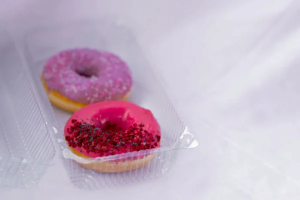 Close Donuts Pink Violet Icing Colored Sprinkles Poppy Seeds Plastic — Stock Photo, Image