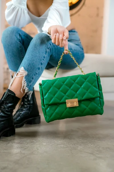 Siyah çantalı şık bir kadın. Omzunda torba olan bir kız. Omuz çantaları kadınlar için. Moda görünümlü kadın kıyafeti. Havalı kadınların bej çantaları. Yakın plan..