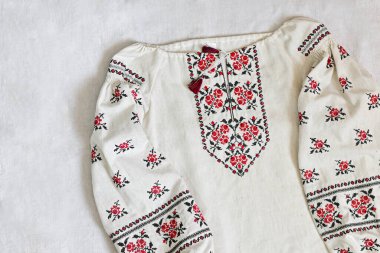 handmade vyshyvanka shirt embroidered with red and black threads. National clothing of Ukraine. Close-up shot, copy space.