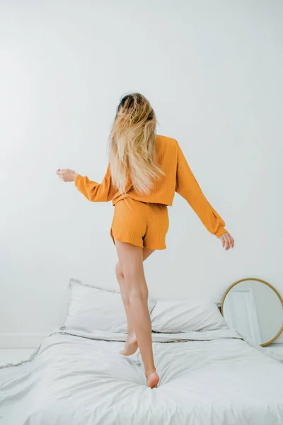 Woman Orange Cotton Pajama Rest Bed Show Smooth Shaved Legs Imagens Royalty-Free