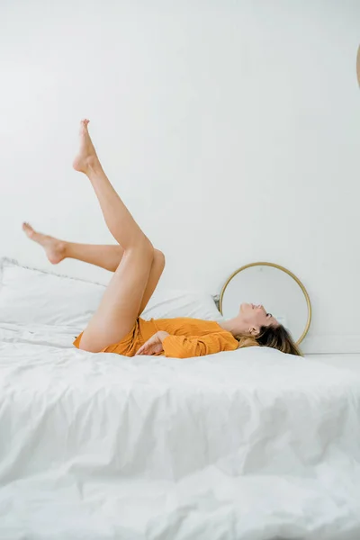 Woman Orange Cotton Pajama Rest Bed Show Smooth Shaved Legs Imagem De Stock