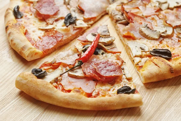 唐辛子ポッドとイタリアのピザのおいしいスライス ロイヤリティフリーのストック画像