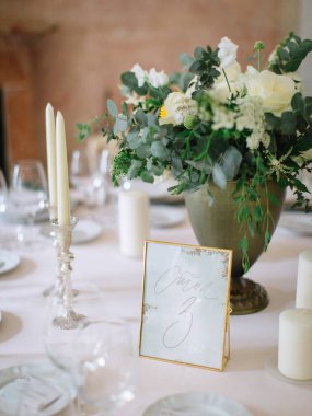 wedding decor, served tables, ivory, with candles, glasses, beautiful wooden tables, inside the Italian old Villa