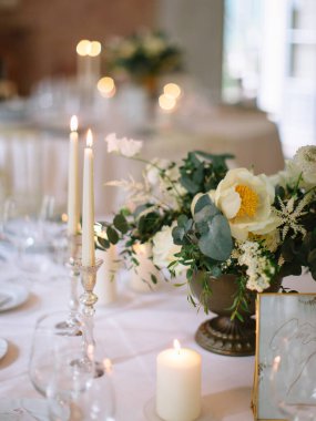 wedding decor, served tables, ivory, with candles, glasses, beautiful wooden tables, inside the Italian old Villa