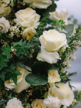 wedding arch of white roses and greenery