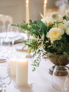 wedding decor, served tables, ivory, with candles, glasses, beautiful wooden tables, inside the Italian old Villa