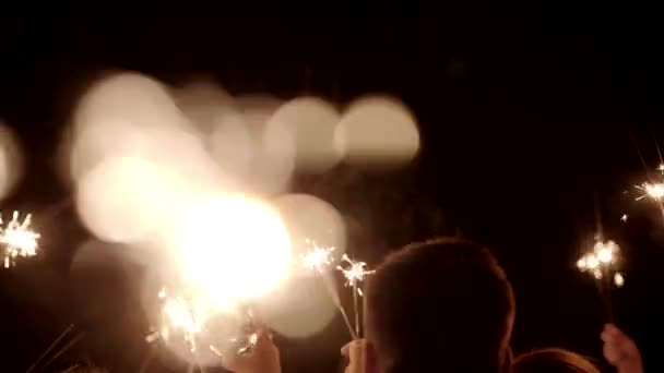 Handen Die Sparkler Vasthouden Vuurwerk Sterretje Branden Met Lichten Achtergrond — Stockvideo