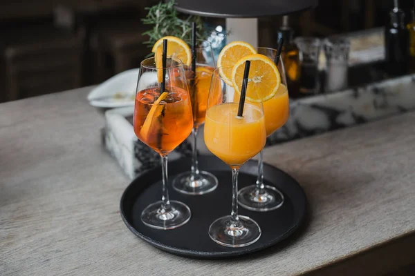 Två Glas Aperol Spritz Cocktails Och Två Glas Juice Träbordet Stockbild