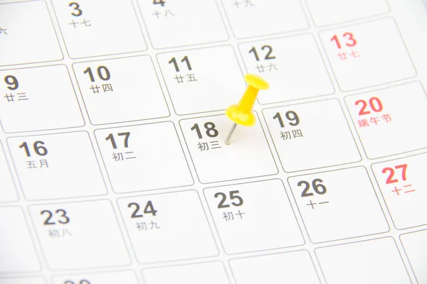 Thumb tack on calendar page