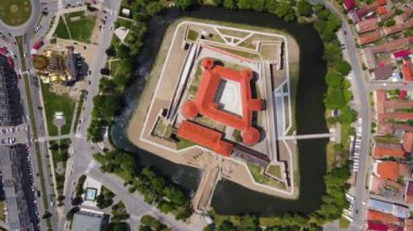 Aerial footage of the Citadel of Fagaras, in Brasov county, Romania. Video was shot from a drone with camera tilted downwards at a lower angle. Birds eye view over medieval fort.