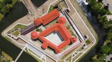 Aerial footage of the Citadel of Fagaras, in Brasov county, Romania. Video was shot from a drone with camera tilted downwards at a lower angle. Birds eye view over medieval fort.