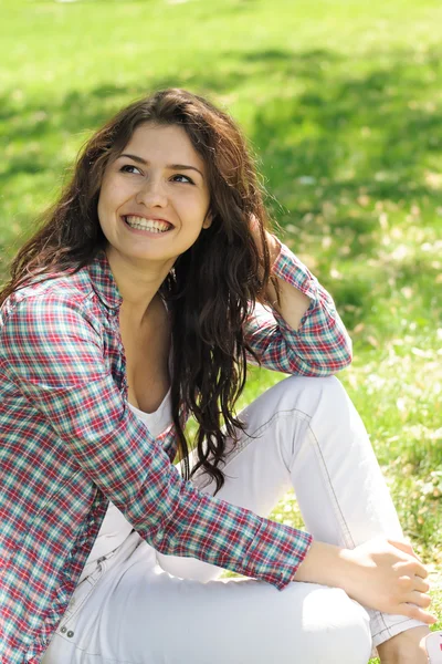 A woman sitting on the grass Stock Image
