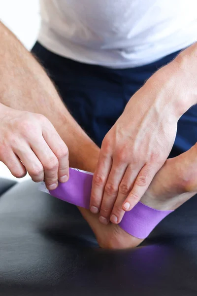 Kinesiology Taping Treatment Purple Tape Male Patient Injured Foot Sports — ストック写真