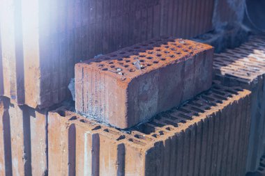Bir yığın kil tuğla. İnşaat için malzeme..