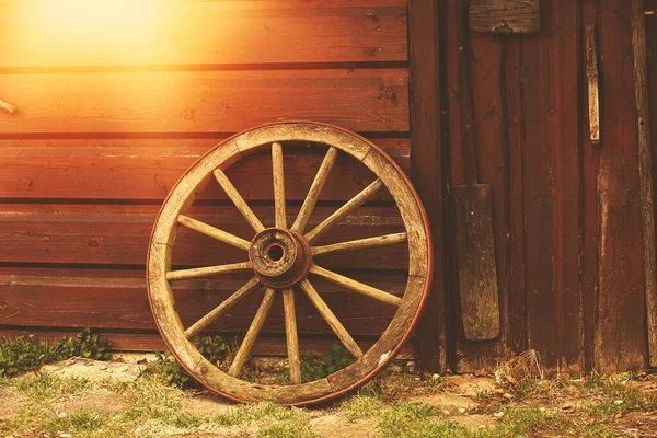 Eski paslı araba tekerleği ahıra yaslanıyor. Köylü aleti. Yüksek kalite fotoğraf