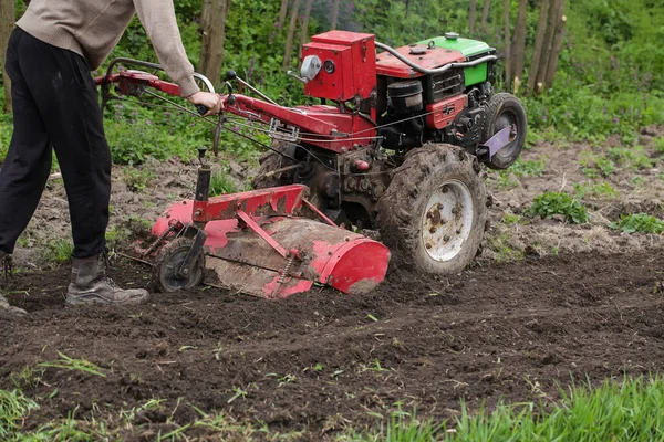 Man farmer working in field ploughing land with plough on farm. Season processing soil in village. Organic cultivate natural products. — Stock Photo, Image