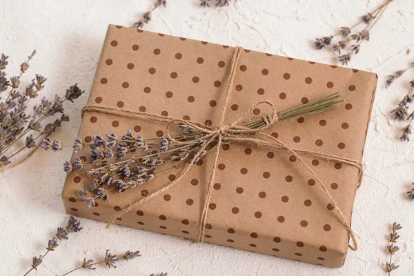 Handmade gift box in craft packaging, dry lavender. Floristic, herbarium craft, zero waste. Natural colours.
