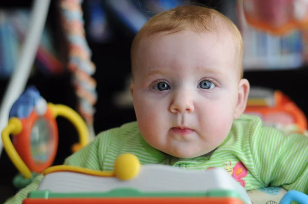 Close-up portrait of cute baby in play gym toy — Stock Photo, Image