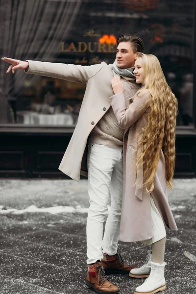 Lovestory couple Love coat beige gray white bouquet of flowers tenderness feelings walk Hug date — Stock Photo, Image