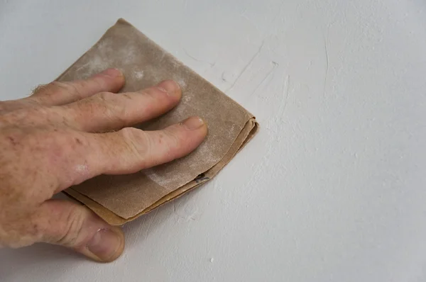 Man with sandpaper — Stock Photo, Image