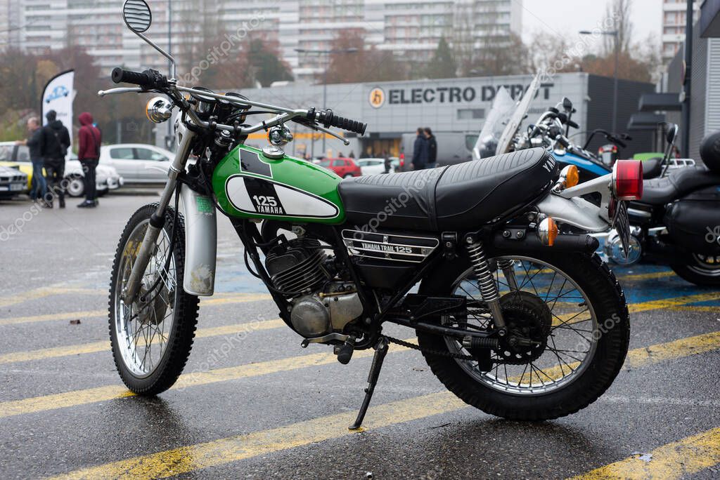 Mulhouse - France - 14 November 2021 - Profile view of green Yamaha motorbike 125CC parked in the street